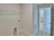 Bright laundry room features neutral walls, overhead storage, and adjacent storage cabinet at 4306 Juliana Lake Dr, Auburndale, FL 33823