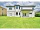 Spacious backyard with a covered patio and a lush green lawn, perfect for outdoor enjoyment at 4312 Juliana Lake Dr, Auburndale, FL 33823