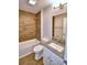 Bathroom featuring granite counters, tiled walls, and a tub and shower combination at 4312 Juliana Lake Dr, Auburndale, FL 33823