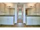 Dual vanity bathroom featuring granite countertops, tiled floors, recessed lighting, and stylish mirrors at 4312 Juliana Lake Dr, Auburndale, FL 33823