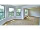 Sun-filled bedroom with large windows and plush carpeting creates a serene and inviting space at 4312 Juliana Lake Dr, Auburndale, FL 33823