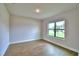 Bedroom features wood-look floors and a window providing natural light at 4312 Juliana Lake Dr, Auburndale, FL 33823