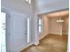 Bright entryway featuring wood-look tile floors, a white door, and views into the dining room at 4312 Juliana Lake Dr, Auburndale, FL 33823