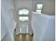 View from the second story down into the dramatic entryway with wood-look floors and soaring ceilings at 4312 Juliana Lake Dr, Auburndale, FL 33823