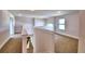 Bright open hallway with natural light, neutral walls, and carpeted floors that is perfect for any decor at 4312 Juliana Lake Dr, Auburndale, FL 33823
