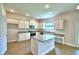 Well-equipped kitchen with granite countertops, white cabinets, and an island with seating at 4312 Juliana Lake Dr, Auburndale, FL 33823