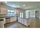 Kitchen featuring stainless steel appliances, granite countertops, white cabinets, and an island at 4312 Juliana Lake Dr, Auburndale, FL 33823