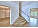 Carpeted staircase leading to the second floor, with views into the dining room and an additional room at 4312 Juliana Lake Dr, Auburndale, FL 33823