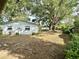 The backyard features lush greenery, mature trees, and a detached garage, creating a serene outdoor space at 4535 Weston Ct, Bartow, FL 33830