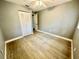 Bright bedroom with wood-look floors, ceiling fan, and closet at 4535 Weston Ct, Bartow, FL 33830