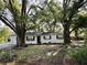 Charming home featuring mature trees, a well-kept lawn, and black shutters at 4535 Weston Ct, Bartow, FL 33830