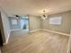 Bright living room featuring stylish lighting fixture and wood-look floors at 4535 Weston Ct, Bartow, FL 33830