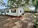 The side yard, featuring mature trees and landscaping, adds to the charm of this home at 4535 Weston Ct, Bartow, FL 33830