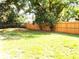 A spacious backyard featuring a newly installed wooden fence, offering privacy and a secure outdoor space at 4629 Harden Blvd, Lakeland, FL 33813