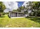 Expansive backyard with a lush lawn and a screened-in porch offering serene outdoor living at 4629 Harden Blvd, Lakeland, FL 33813