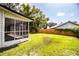 The backyard features a fenced-in yard, a screened-in porch and plenty of greenery at 4629 Harden Blvd, Lakeland, FL 33813