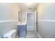 Neutral bathroom with gray vanity, beadboard paneling, and tile floors, creating a fresh and updated look at 4629 Harden Blvd, Lakeland, FL 33813