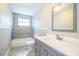 Updated bathroom featuring a gray vanity, shower-tub combo with tile surround, and natural light at 4629 Harden Blvd, Lakeland, FL 33813