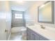 Updated bathroom featuring modern vanity, new tile floors, and a shower-tub combo at 4629 Harden Blvd, Lakeland, FL 33813
