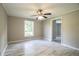 Spacious bedroom featuring a ceiling fan, large window, and vinyl flooring at 4629 Harden Blvd, Lakeland, FL 33813
