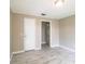 Bright and spacious bedroom featuring neutral paint, tile flooring, and an open doorway at 4629 Harden Blvd, Lakeland, FL 33813
