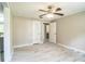 Spacious bedroom with ceiling fan, vinyl floors, and neutral walls at 4629 Harden Blvd, Lakeland, FL 33813