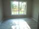 Bedroom featuring new flooring, a large window looking out to the backyard, and neutral color scheme at 4629 Harden Blvd, Lakeland, FL 33813