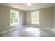 Bright bedroom with natural light from large windows and neutral paint, complemented by marble-look floors at 4629 Harden Blvd, Lakeland, FL 33813