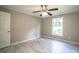 Bedroom featuring a ceiling fan, a large window, neutral walls and vinyl floors at 4629 Harden Blvd, Lakeland, FL 33813