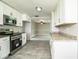 Updated kitchen showcases white cabinets, stainless steel appliances, and granite countertops, open to living area at 4629 Harden Blvd, Lakeland, FL 33813
