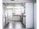 Bright kitchen featuring white cabinets, stainless steel appliances, gray tile flooring, and granite countertops at 4629 Harden Blvd, Lakeland, FL 33813