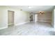 Expansive living room with modern flooring, neutral color scheme, ceiling fan, and access to other rooms at 4629 Harden Blvd, Lakeland, FL 33813