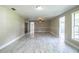 Bright and airy living room features a ceiling fan, updated base trim molding, and modern flooring at 4629 Harden Blvd, Lakeland, FL 33813