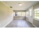 Bright living room with multiple windows and a door at 4629 Harden Blvd, Lakeland, FL 33813