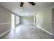 Spacious living room with contemporary flooring, neutral paint, ceiling fan, and abundant natural light at 4629 Harden Blvd, Lakeland, FL 33813