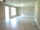 Bright living room featuring new flooring, trim, large window, and neutral color scheme at 4629 Harden Blvd, Lakeland, FL 33813