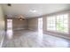 Spacious living room featuring marble floors, ceiling fan, and natural light from large windows at 4629 Harden Blvd, Lakeland, FL 33813