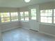 Bright sunroom featuring tile floors, multiple windows, and natural light at 4629 Harden Blvd, Lakeland, FL 33813