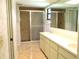 Bathroom with double sinks and tiled shower at 5070 Ironwood Trl, Bartow, FL 33830