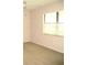 Bedroom with neutral walls, beige carpet, and a large window at 5070 Ironwood Trl, Bartow, FL 33830