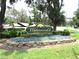 Attractive Waterwood II community sign surrounded by lush greenery and vibrant flowers at 5070 Ironwood Trl, Bartow, FL 33830