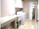 Laundry room equipped with washer, dryer, sink and a folding table at 5070 Ironwood Trl, Bartow, FL 33830