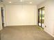 Neutral living room with sliding glass doors and ceiling fan at 5070 Ironwood Trl, Bartow, FL 33830