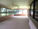 Bright sunroom with many windows and ceiling fans, offering views of backyard at 5070 Ironwood Trl, Bartow, FL 33830