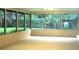 Sun room with large windows overlooking a lush green yard at 5070 Ironwood Trl, Bartow, FL 33830