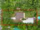 An aerial view of the home outlined, with mature trees, backyard pool, and driveway at 5120 Lunn Rd, Lakeland, FL 33811