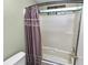 Bathroom features a shower with a beige tile surround and decorative curtain at 5120 Lunn Rd, Lakeland, FL 33811