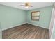 Bedroom featuring wood-look flooring, a ceiling fan and a large window at 5120 Lunn Rd, Lakeland, FL 33811
