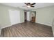 Spacious bedroom with tiled floors, a ceiling fan, and access to an ensuite bathroom at 5120 Lunn Rd, Lakeland, FL 33811