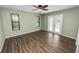 Light-filled bedroom with ceiling fan, wood-look floors, and sliding glass doors at 5120 Lunn Rd, Lakeland, FL 33811